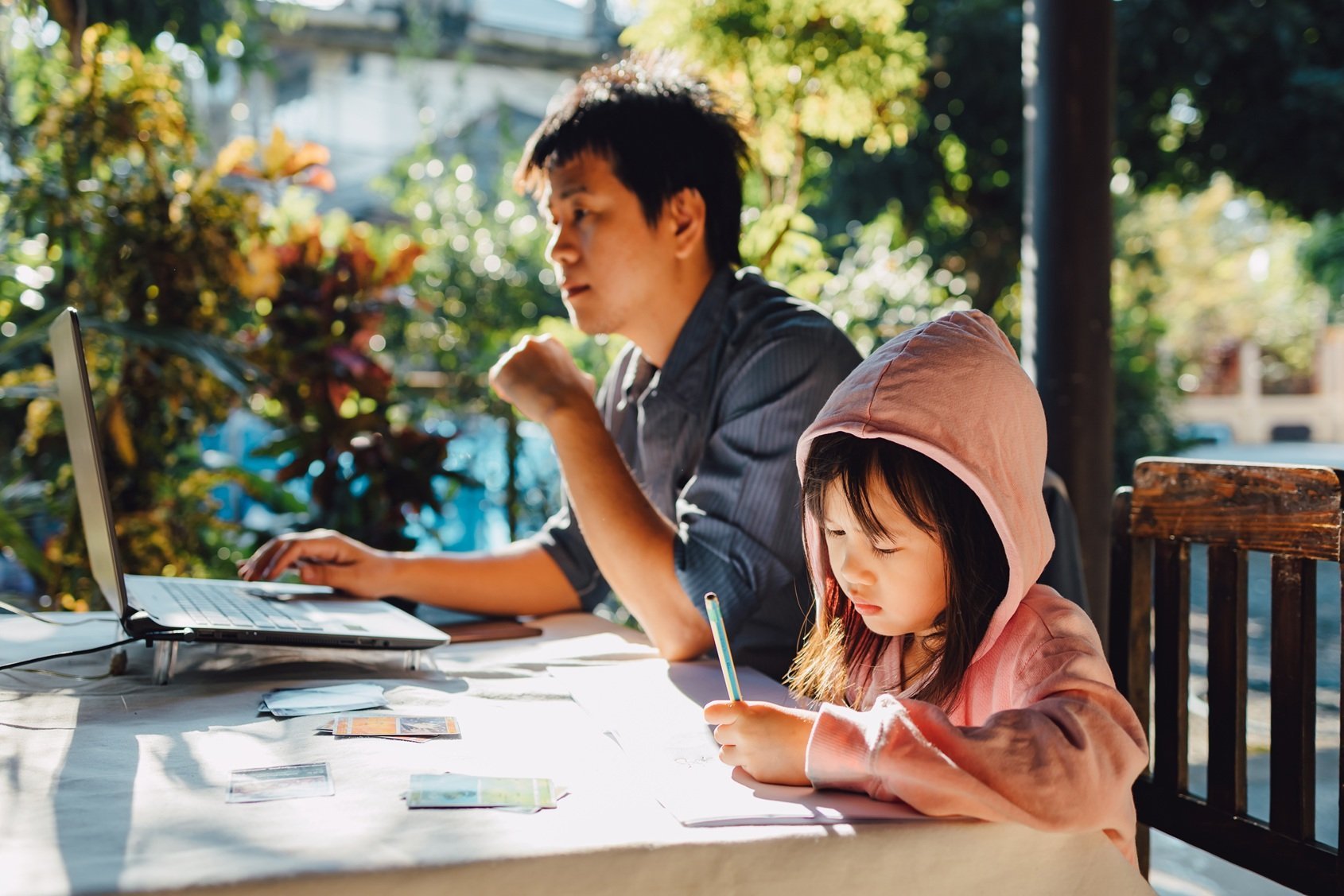 adult-and-child-working-at-table-outside-2026-03-16-00-43-11-utc