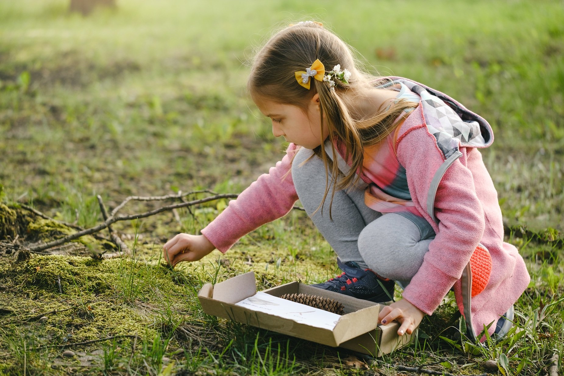 child-exploring-nature-placing-items-in-container-2026-03-19-09-33-09-utc