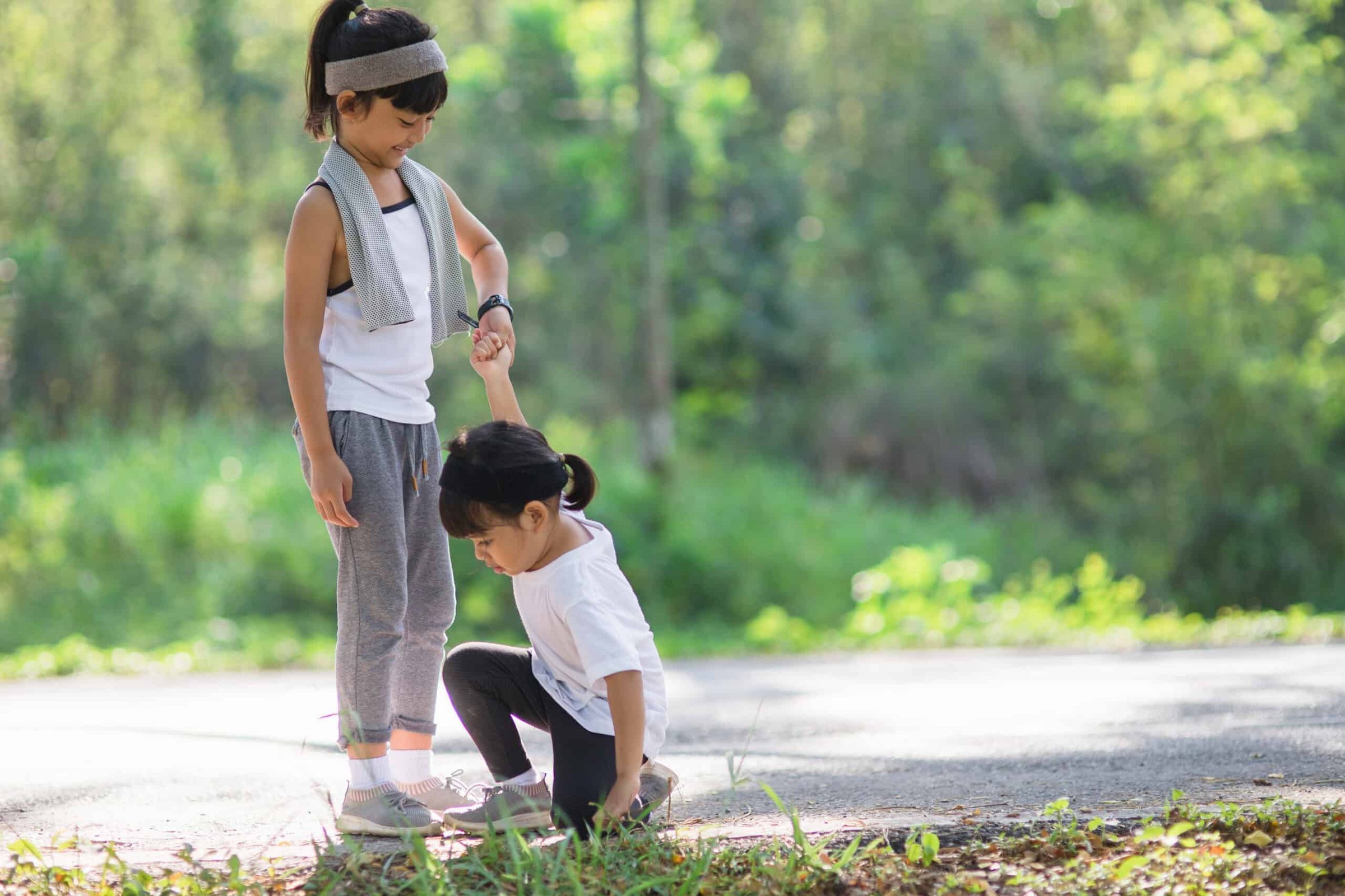 cute-asian-girl-give-hand-to-help-sister-accident-2025-02-14-06-24-31-utc-scaled