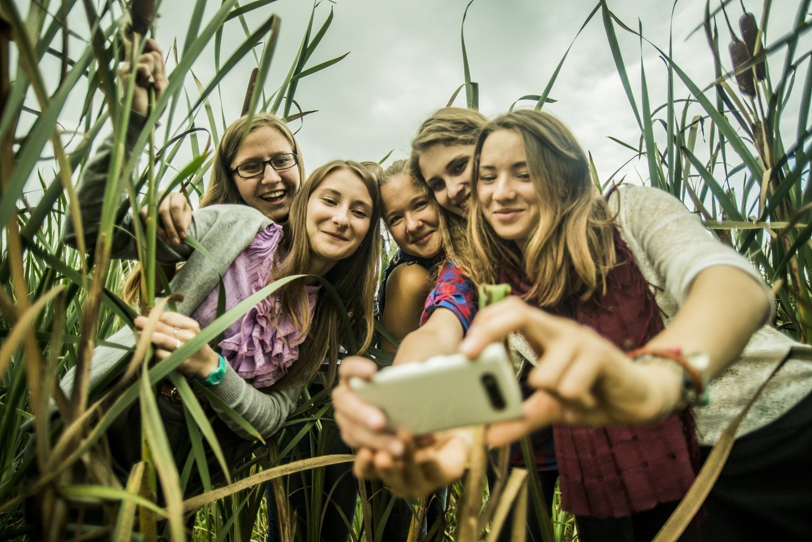 five-young-women-taking-self-portrait-in-marshes-2026-03-25-01-31-13-utc