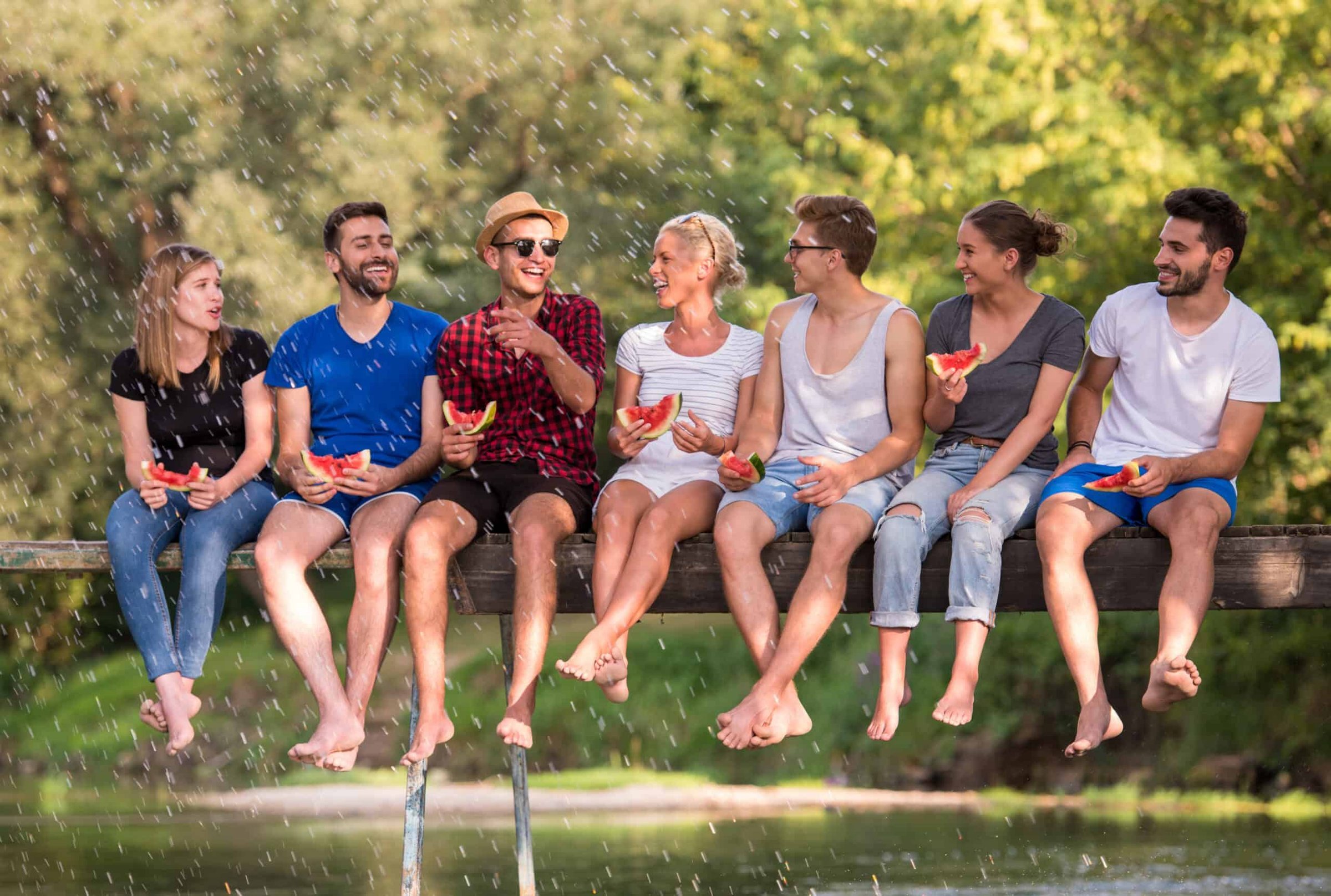friends-enjoying-watermelon-while-sitting-on-the-w-2025-01-15-14-41-50-utc-scaled
