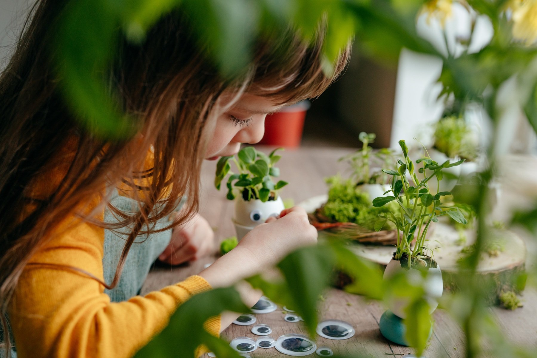 girl-decorating-eggshell-planters-with-googly-eyes-2026-03-17-08-59-24-utc