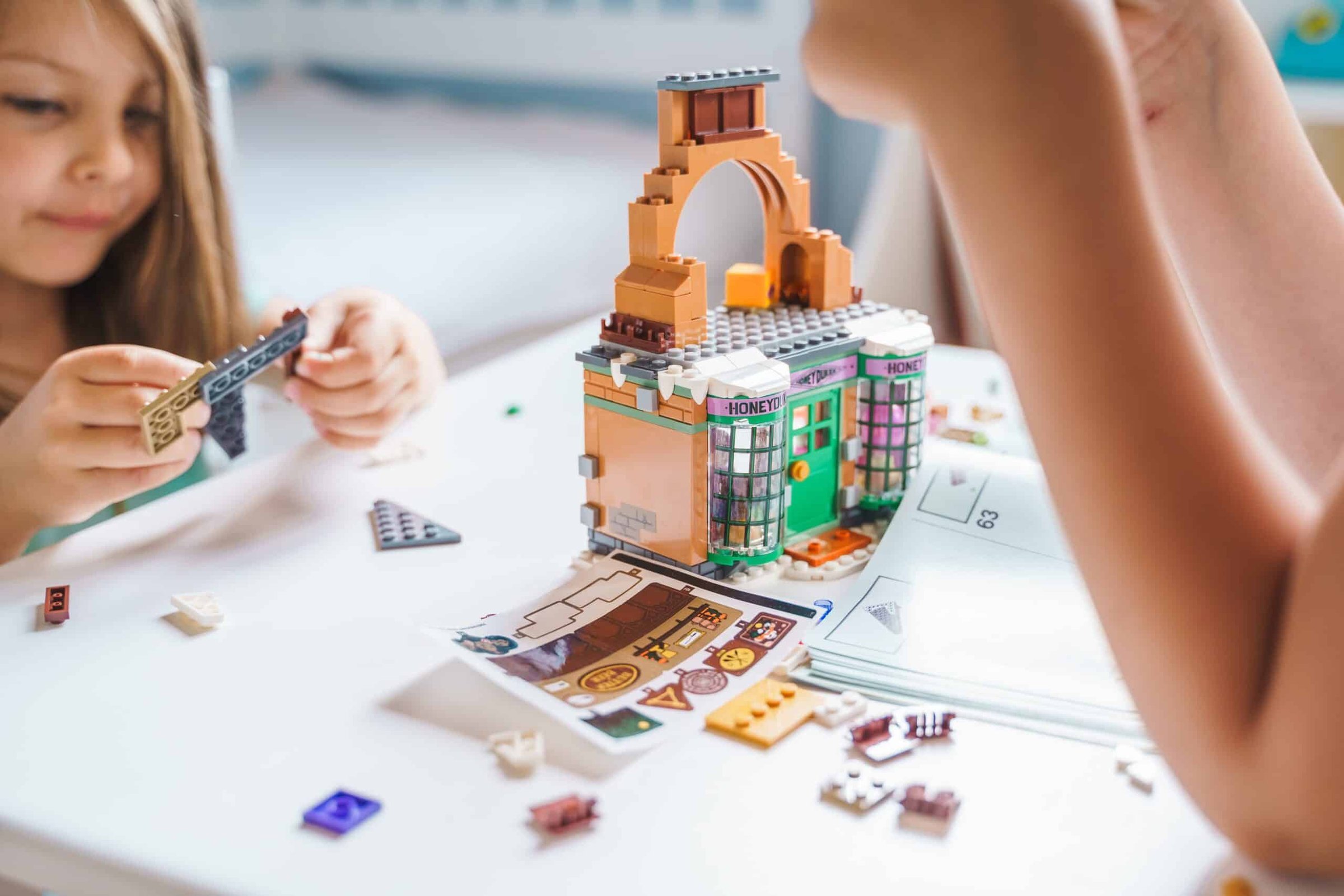 girls-sisters-play-kids-constructor-build-house-2024-11-26-09-48-16-utc-scaled