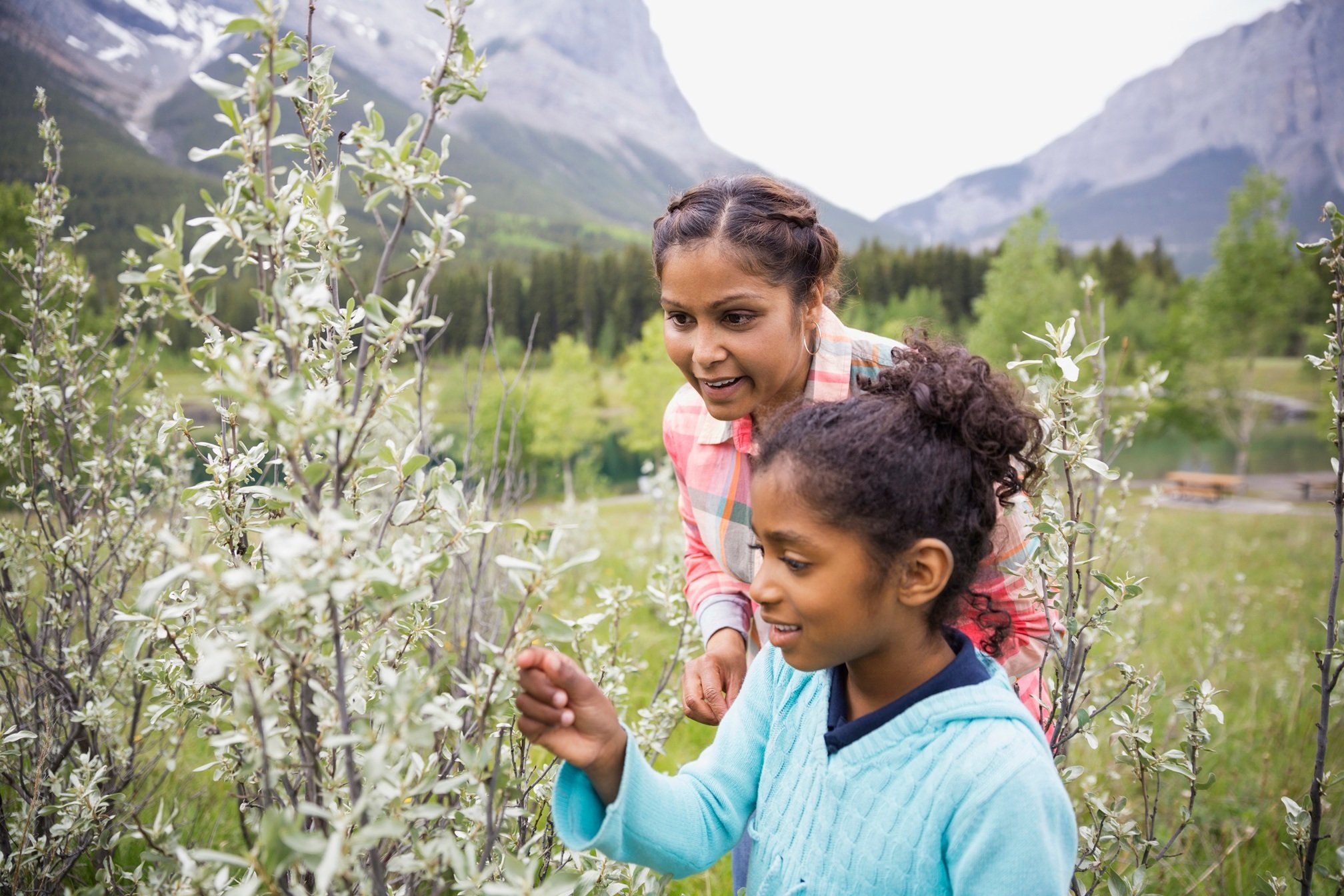 mother-and-daughter-looking-at-plant-in-field-2026-03-26-05-07-54-utc