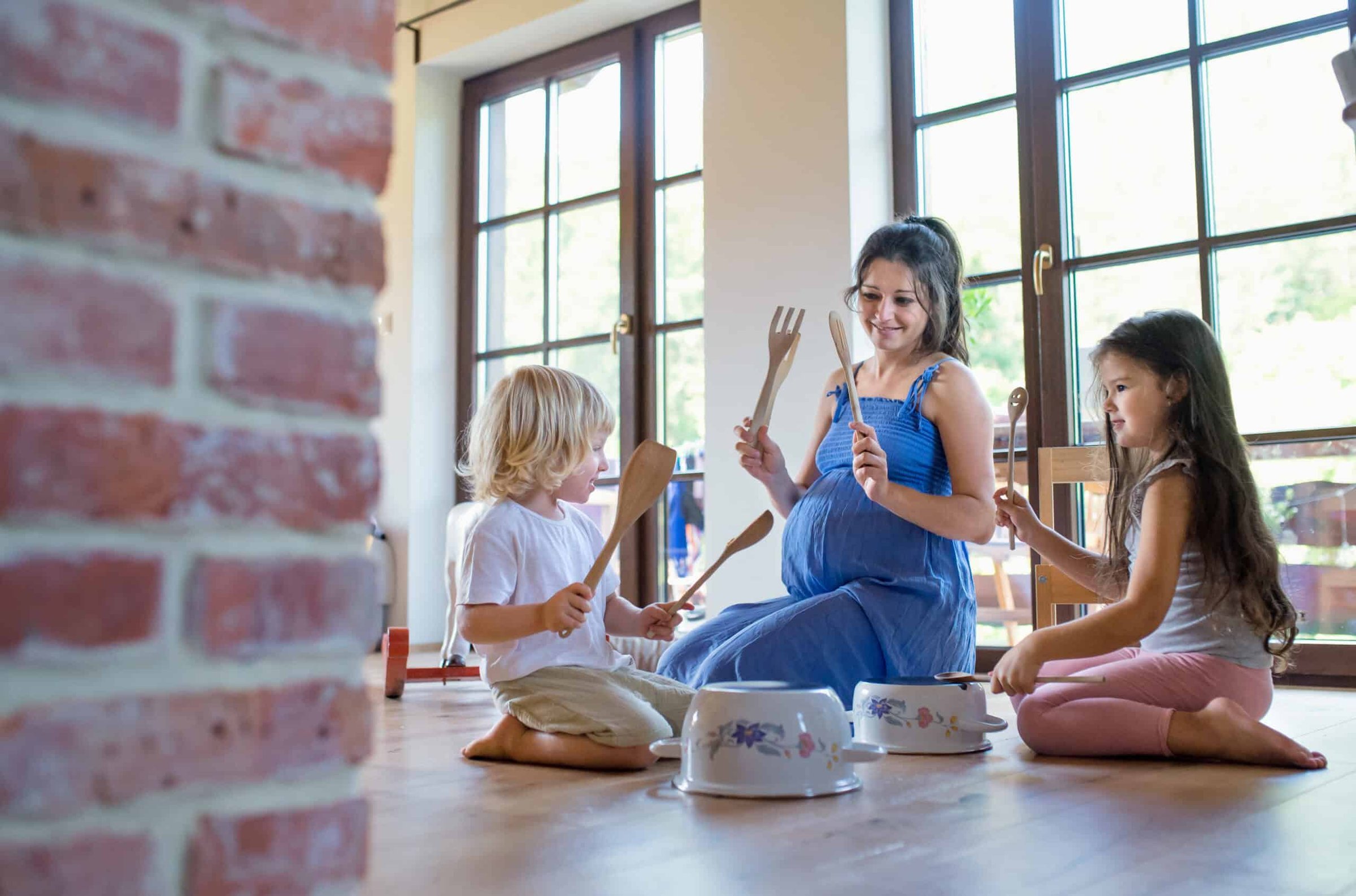 pregnant-woman-with-small-children-indoors-at-home-2024-10-21-16-40-03-utc-scaled