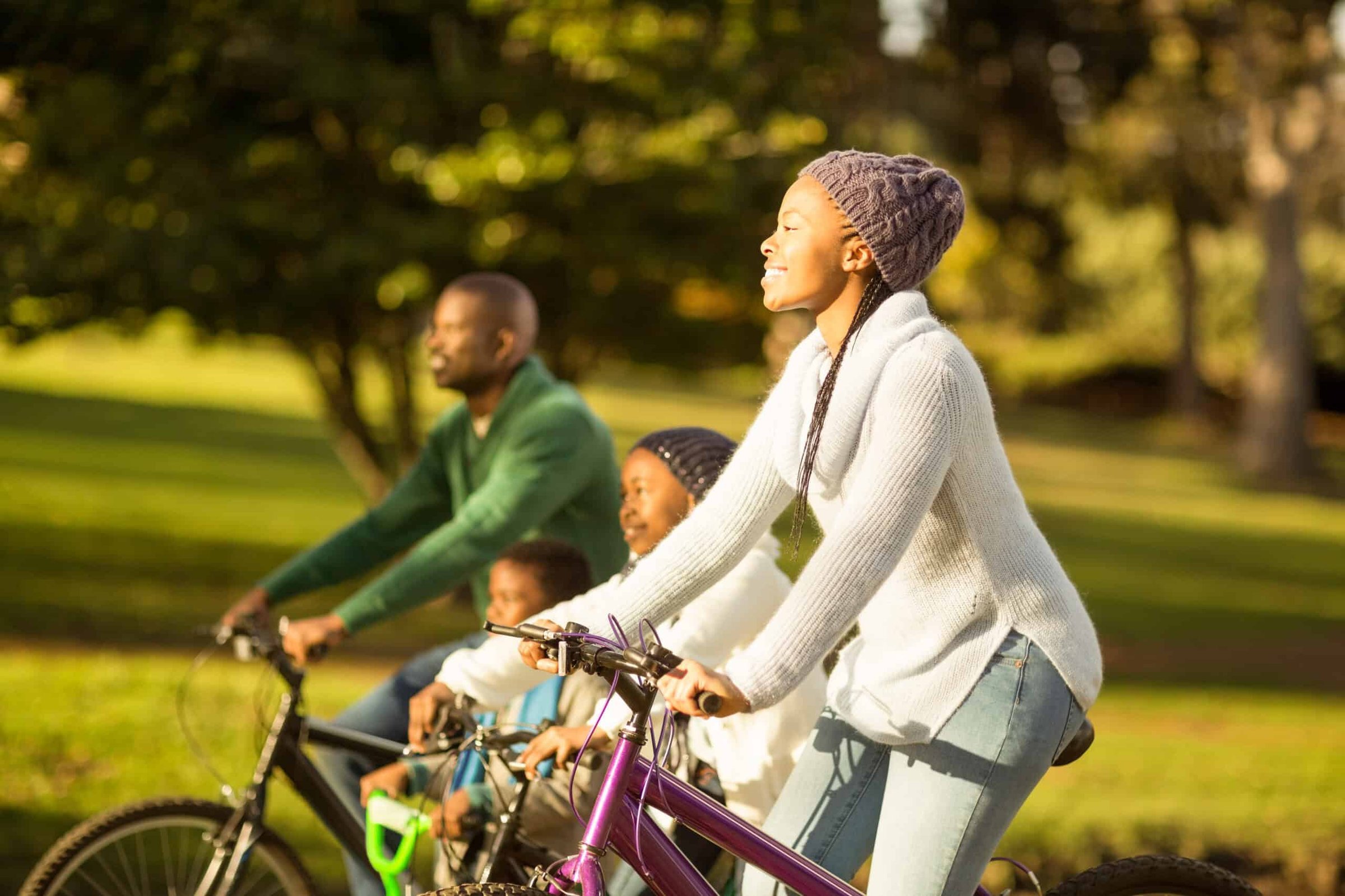 side-view-of-a-young-family-doing-a-bike-ride-on-a-bike