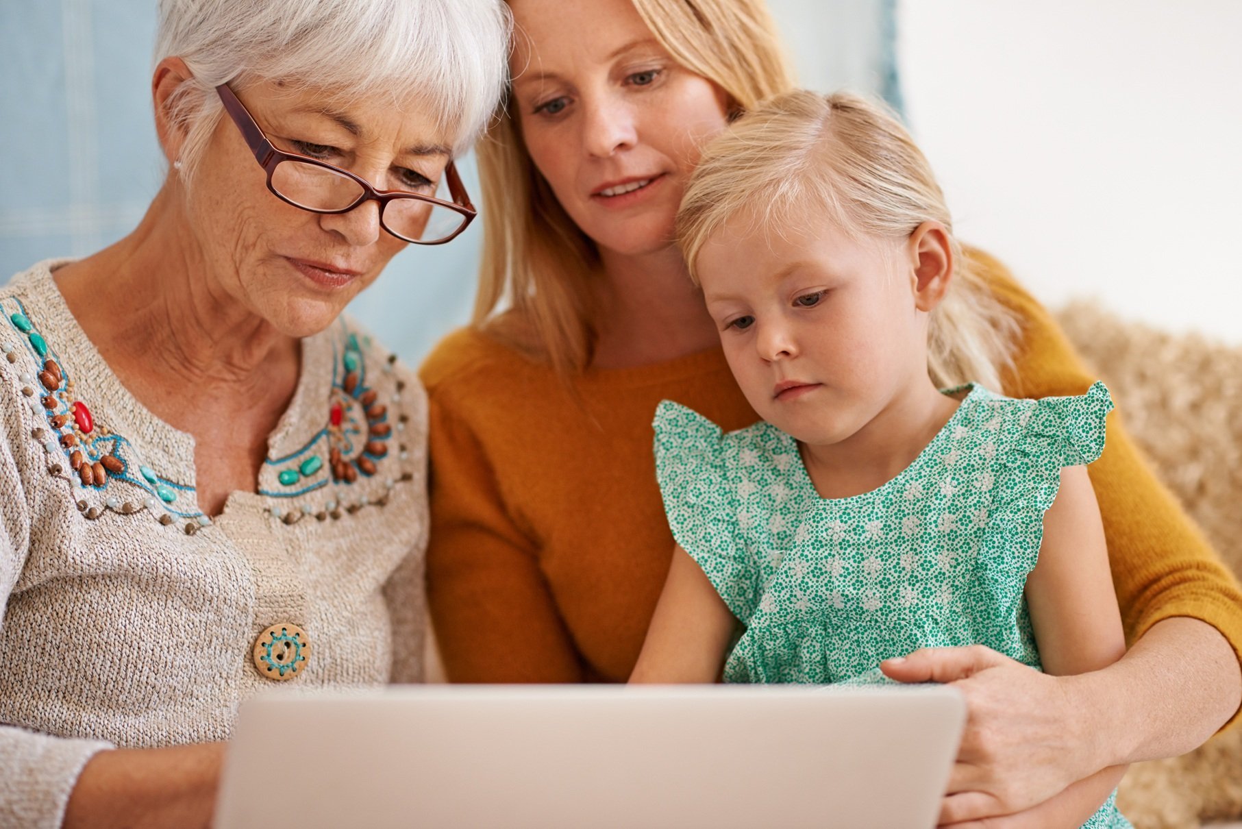 three-generations-gathered-around-a-laptop-2026-03-25-03-04-28-utc