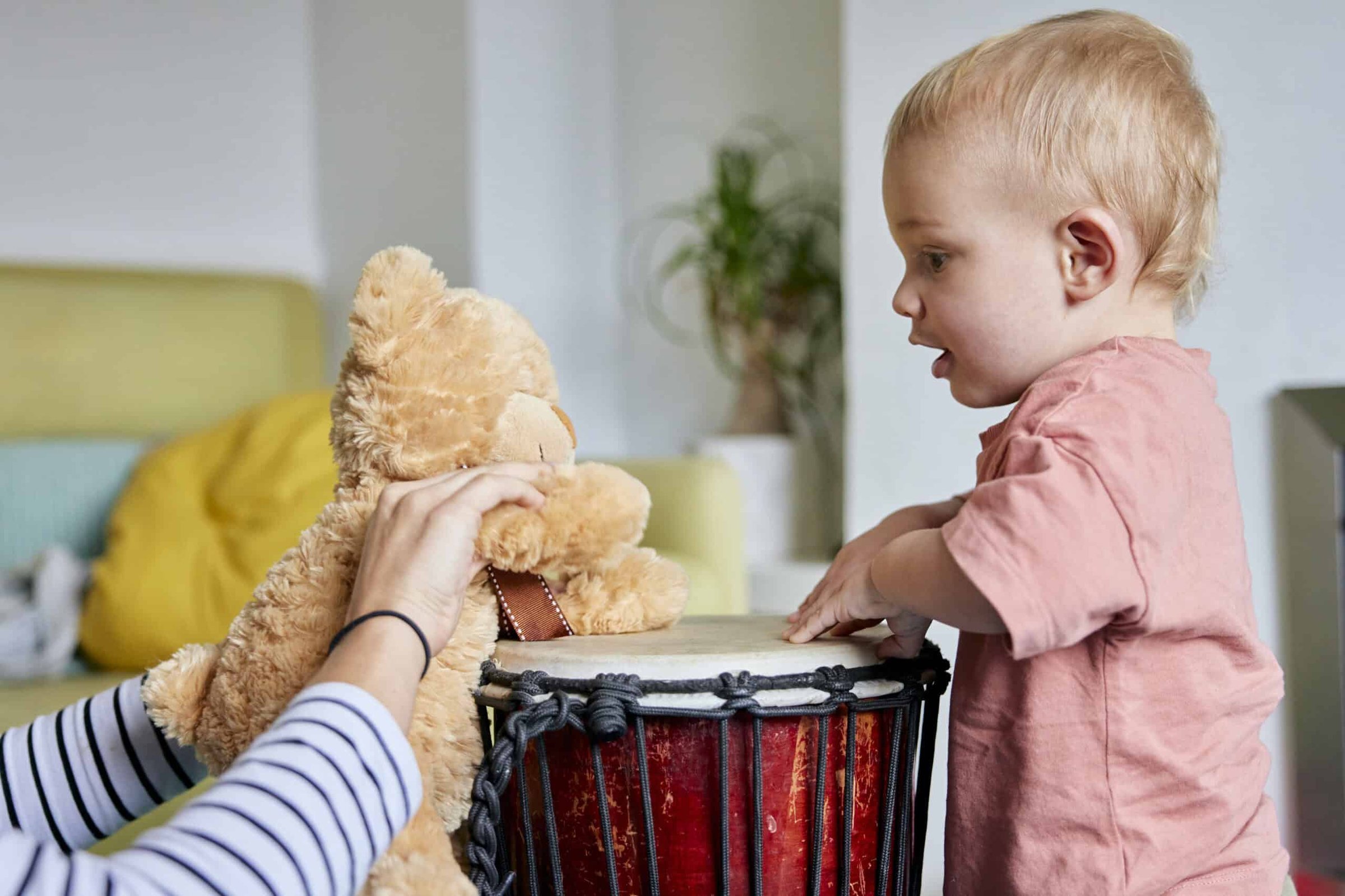 toddler-and-teddy-bear-playing-bongo-drum-together-2025-04-04-16-21-33-utc-scaled