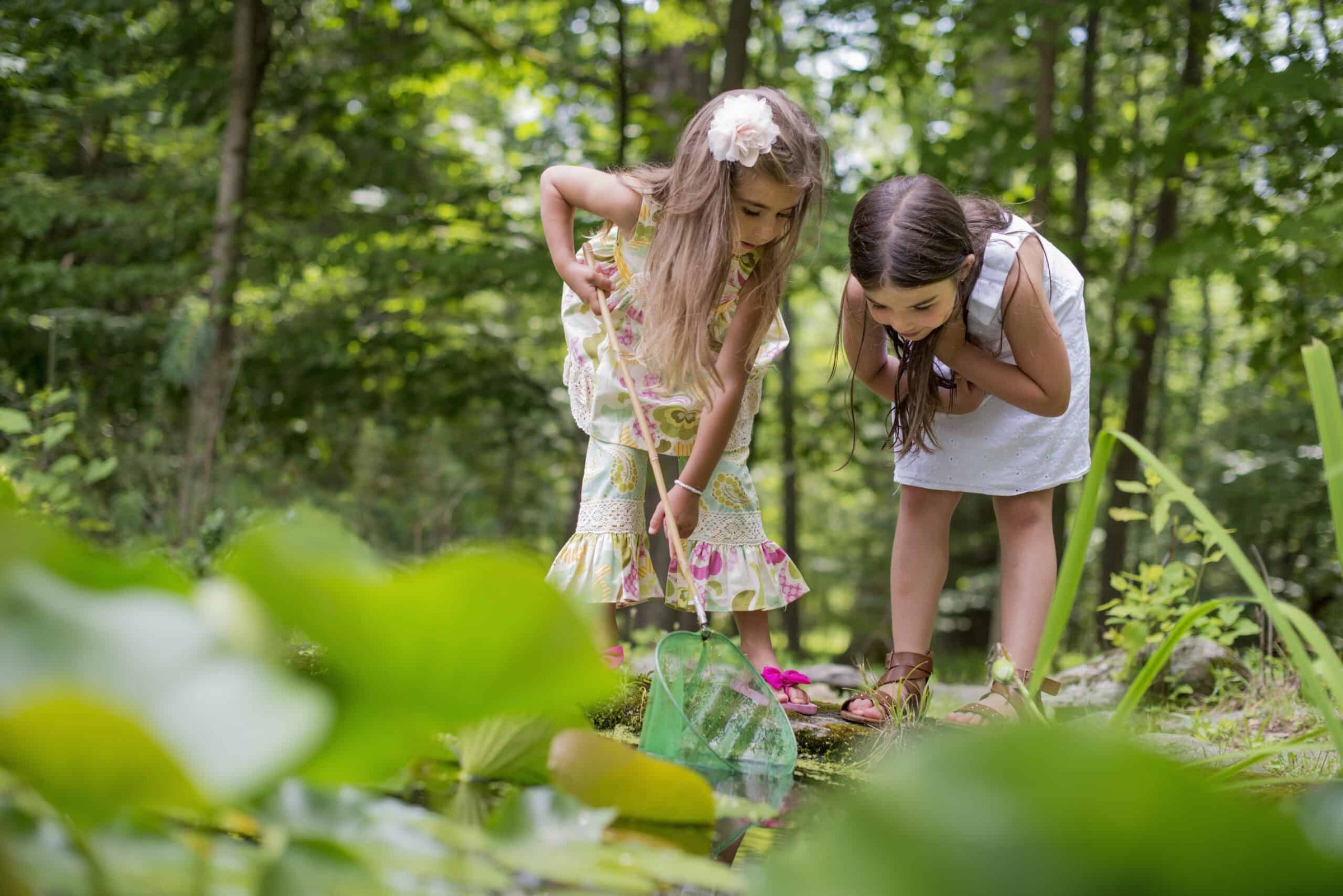 two-girls-playing-at-a-pond-in-a-forest-2025-04-05-05-03-05-utc-scaled