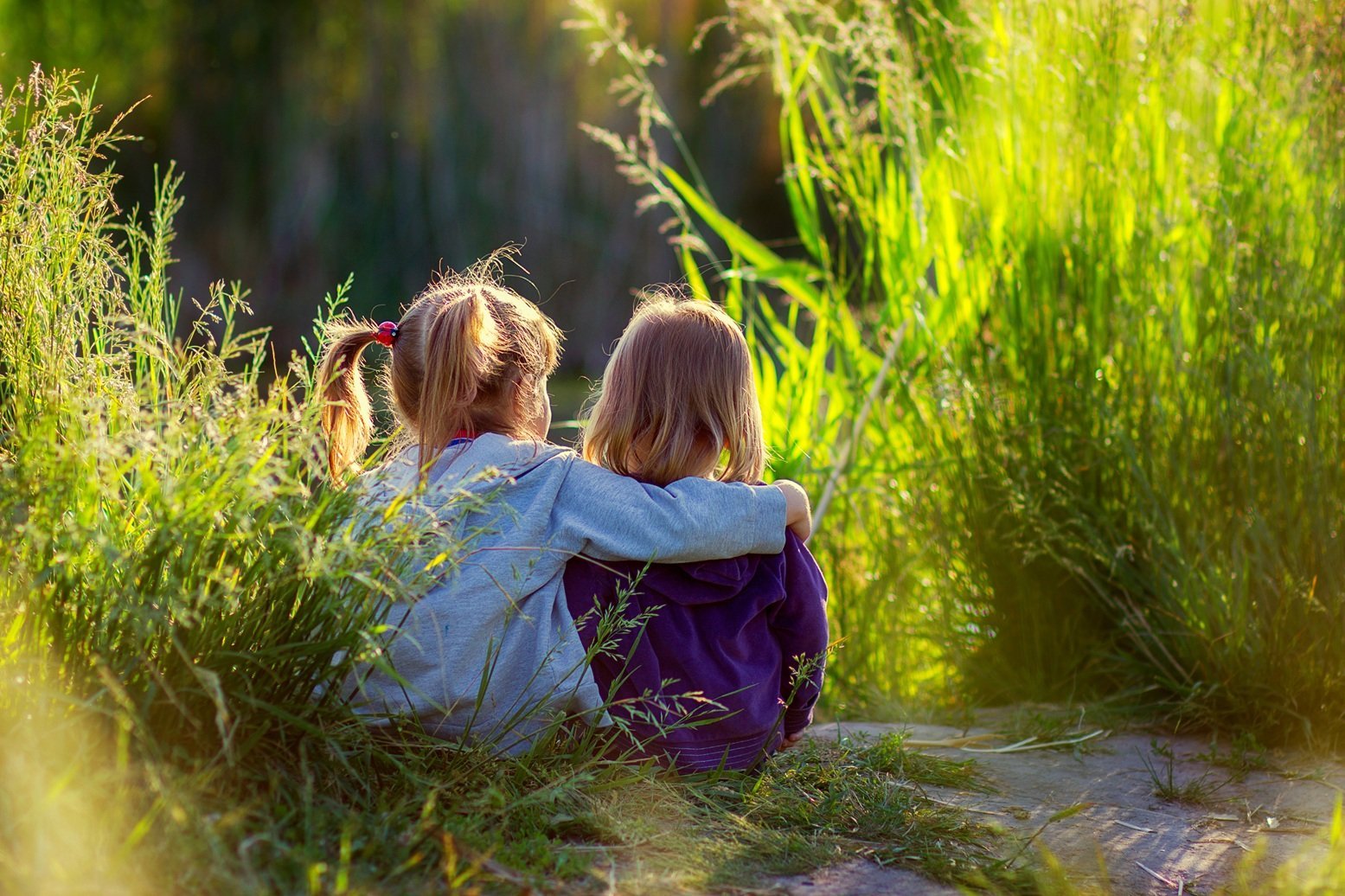 two-little-girls-sit-having-embraced-on-the-bank-o-2026-03-17-05-01-54-utc