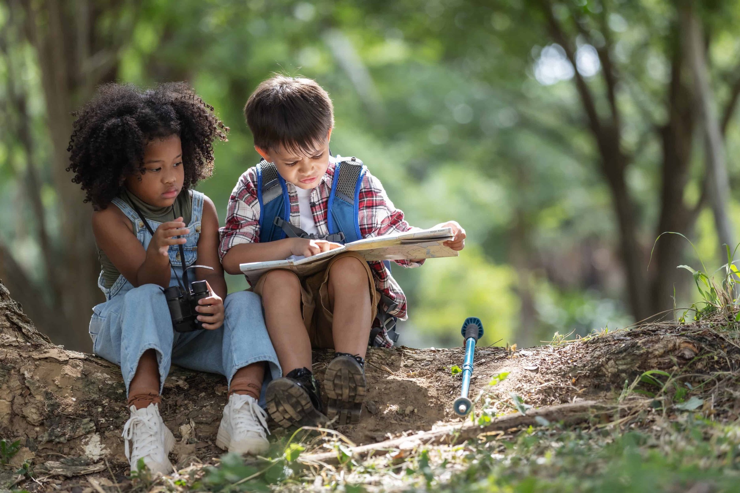 two-young-adventurers-sit-under-a-tree-in-a-forest-2025-02-13-18-03-26-utc