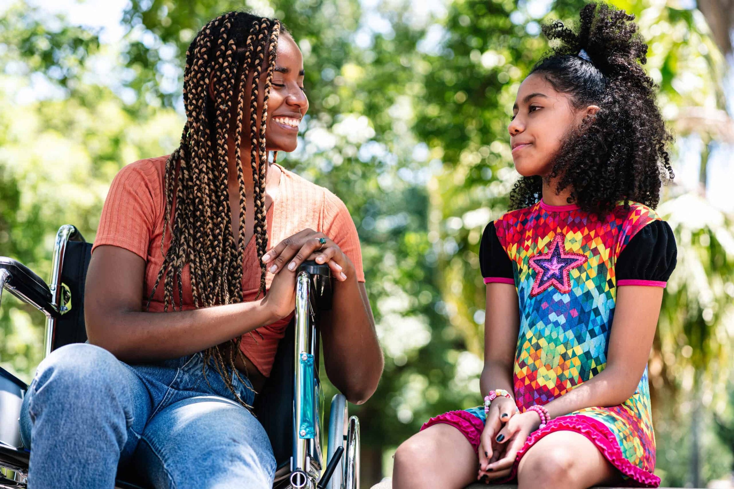 woman-in-a-wheelchair-at-the-park-with-her-daughte-2024-10-15-04-36-06-utc-scaled
