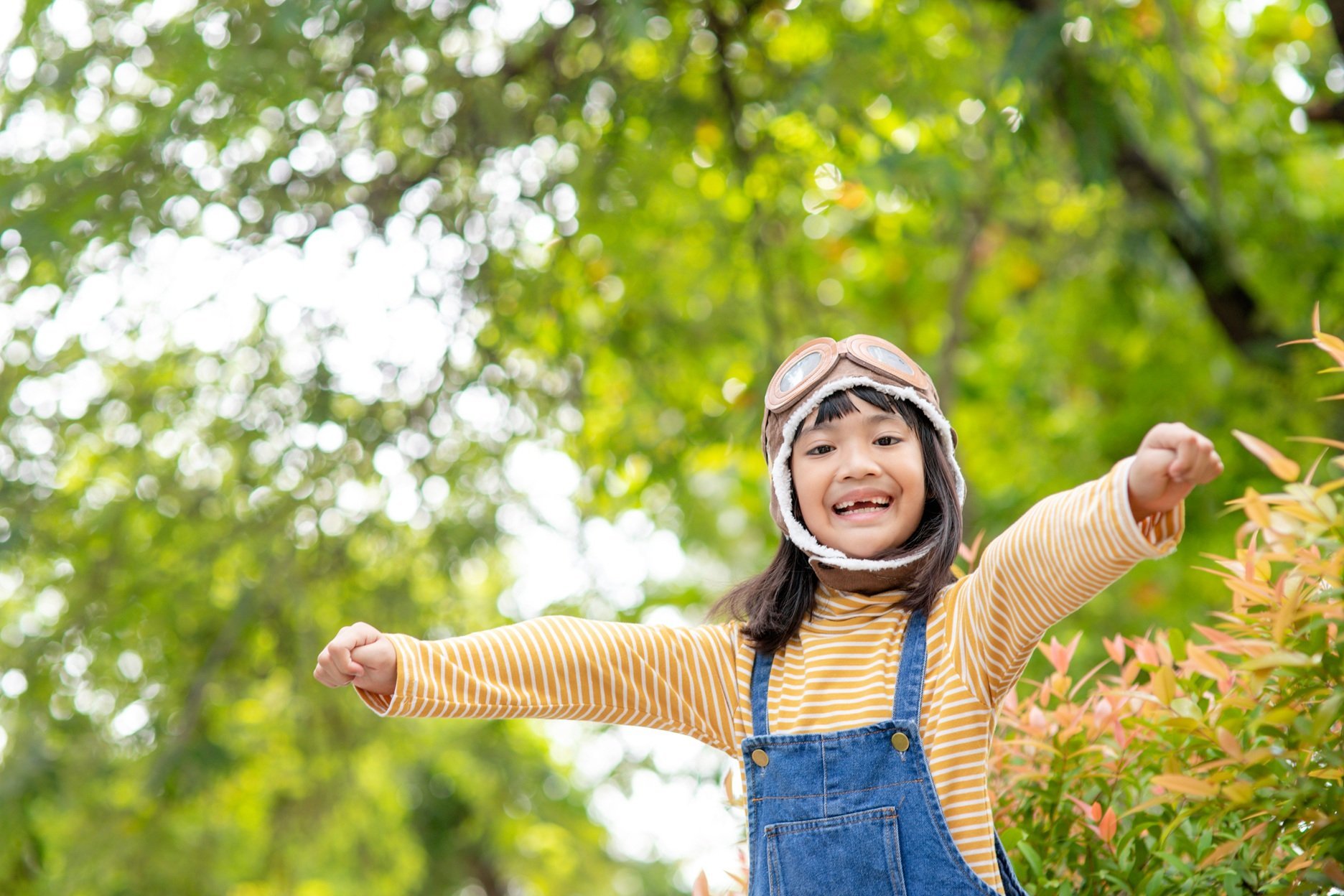 young-girl-pretending-to-fly-in-nature-setting-2026-03-19-02-22-23-utc